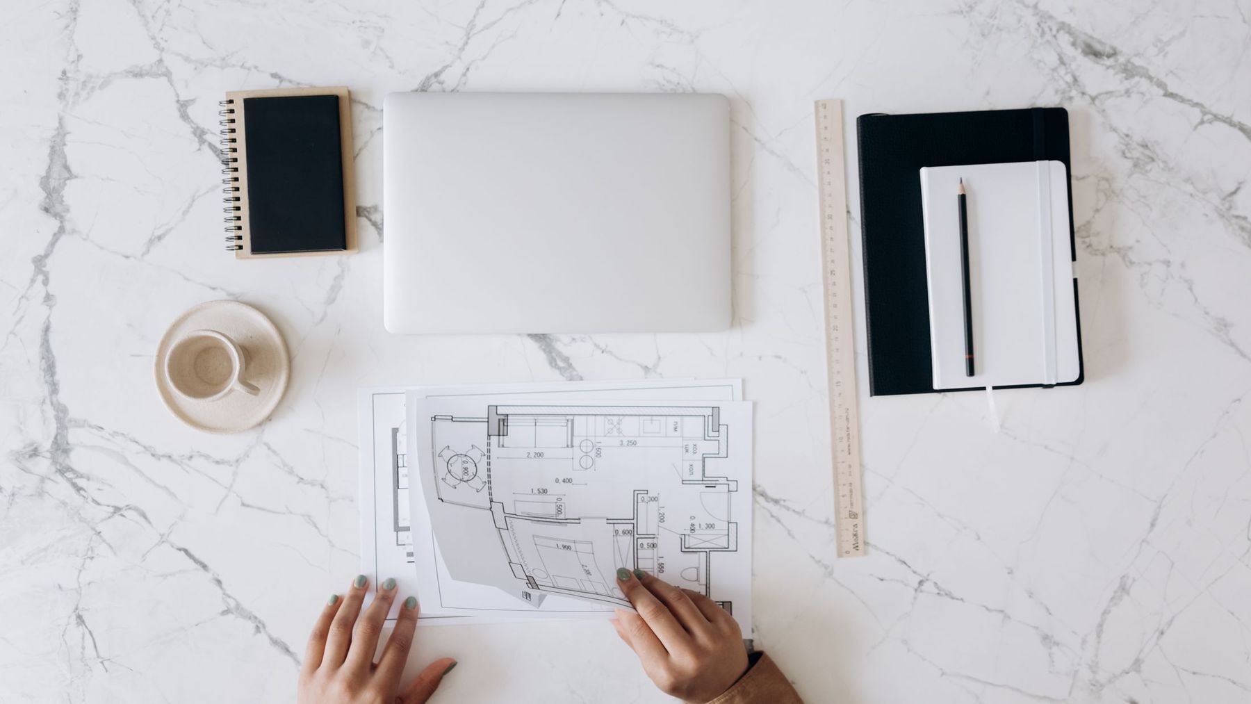 Plans and drawings laid out on a table