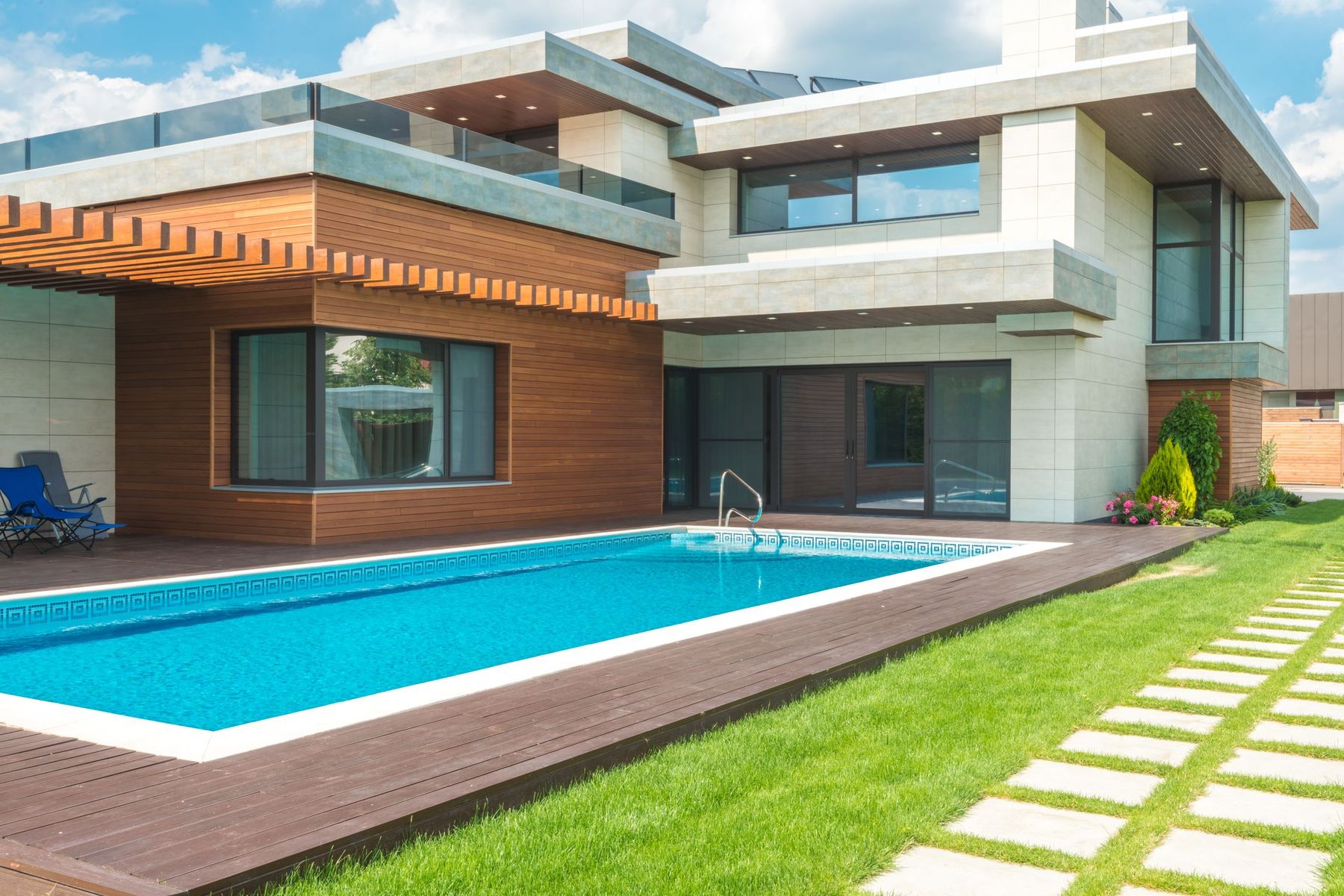 Custom home exterior with pool at twilight